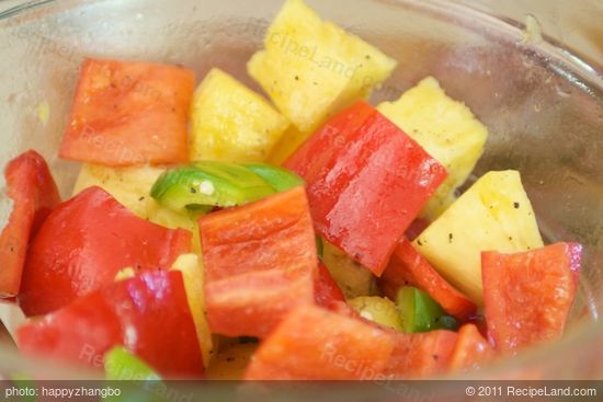 Add the pineapple chunks and bell peppers, 1 1/2 tablespoons of olive oil, salt and black pepper to taste in a medium bowl, toss until well coated.