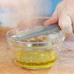 Grate some fresh garlic.