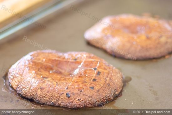 Carefully transfer the caps, gill-side up, on the preheated baking sheet.