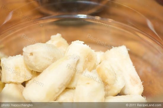 Peel the bananas, tear them into pieces, and add into a large mixing bowl.