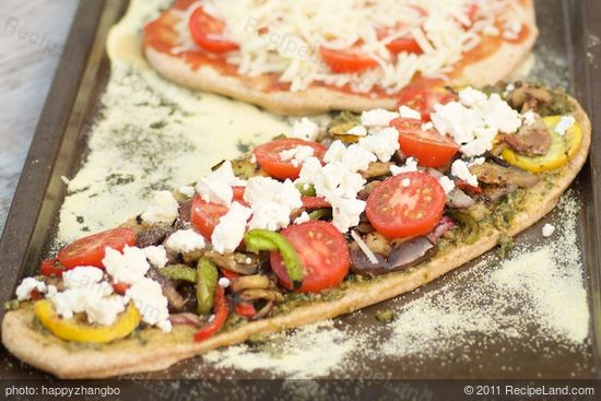 Spoon the basil pesto onto the surface and spread it evenly. 