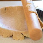 Wrap the pastry around the rolling pin and unroll it over the tart pan. 