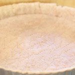 Put the tart pan on a baking sheet and bake until the edge looks dry, about 10 minutes.