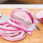 Peel, half and slice the onions lengthwise into 1/4-inch-thick slices.
