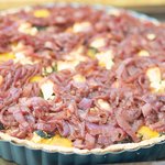 When the tart is baked, arrange the balsamic onions over the top of the tart, allowing bits of cheese to peek through. 
