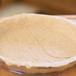 Trim the edges off by rolling the pin over the crust.