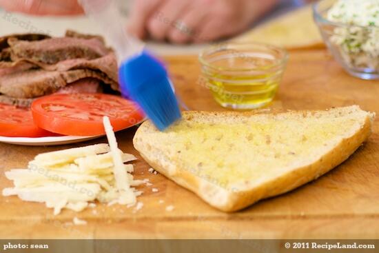 Brush bread with garlic oil