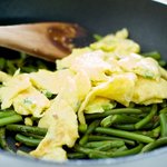 Return the scrambled eggs into the wok or pan, 