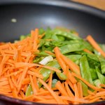 Stir in the snow peas and carrots, 
