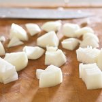Halve the onion lengthwise, cut into 1-inch cubes and each cube will have several layers.