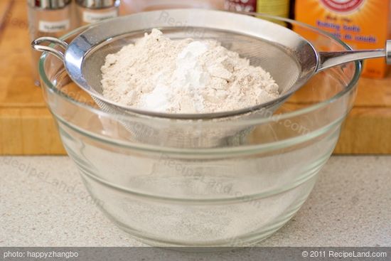 Add the flour, baking powder, and baking soda into a fine sieve over a large bowl.