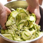Place the zucchini, onion and salt in a colander, toss to coat and place over a bowl. 