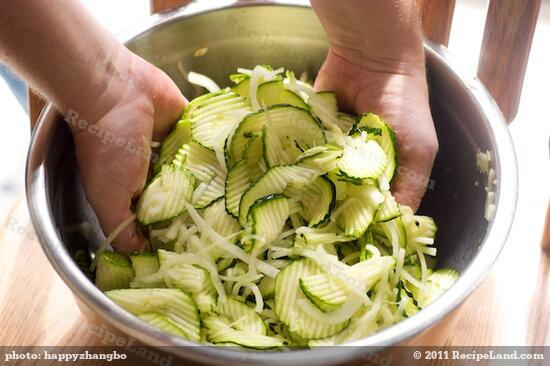 Place the zucchini, onion and salt in a colander, toss to coat and place over a bowl. 