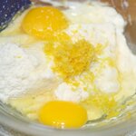 Add the cheese, eggs and lemon zest into a large mixing bowl.