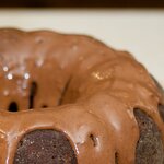 The cake is well glazed by chocolate glaze, shiny and smooth.