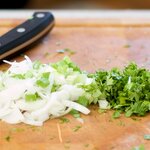 Then thinly slice the scallions, and chop the fresh cilantro as well.
