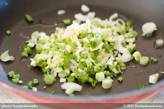 Heat the oil in a wok or nonstick skillet until hot, add the garlic, ginger and scallions.