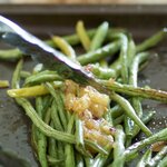 Pour the sauce over the partially roasted green beans.