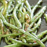 With tongs stir the green beans until evenly coated.