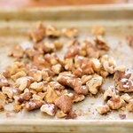 Return the baking sheet with walnuts into the oven,