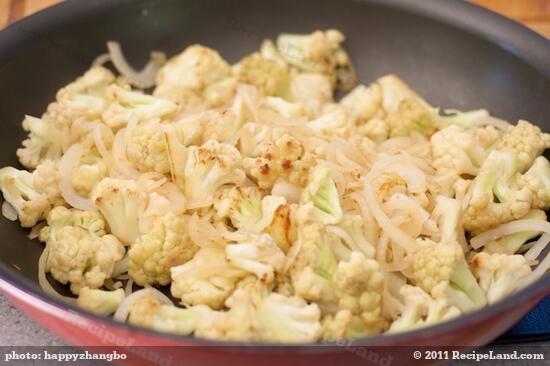 Keep cooking until the cauliflower florets starts to brown and onions are soft, 4 to 5 minutes. 