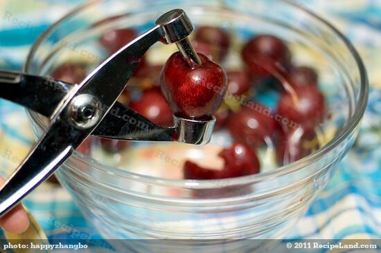 Pit the cherries with a cherry pitter over a <a href=