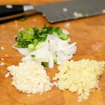 Meanwhile mince the fresh garlic, ginger and thinly slice the scallions.