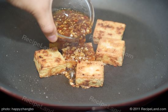 Reduce the heat to low, pour half of the sauce into the pan,