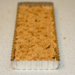 Turn dough out into tart pan coated with cooking spray (it will be crumbly),