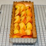 Arrange peach slices neatly over tart.