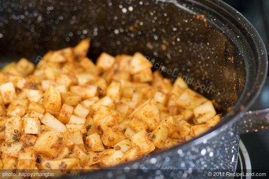 Spread the potato cubes evenly into a baking pan.