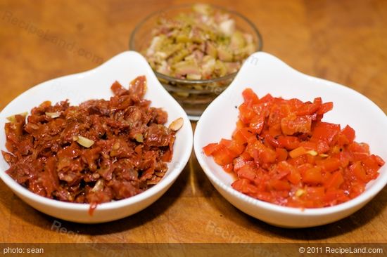 Meanwhile chop up the sun-dried tomatoes, olives and roasted bell peppers.