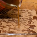 Pour the coffee slowly from spot to spot.