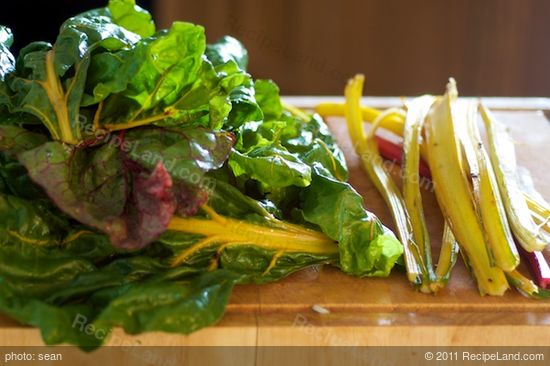 Meanwhile wash the chard very well, chop off the tough ends, and separate the stems and leaves.