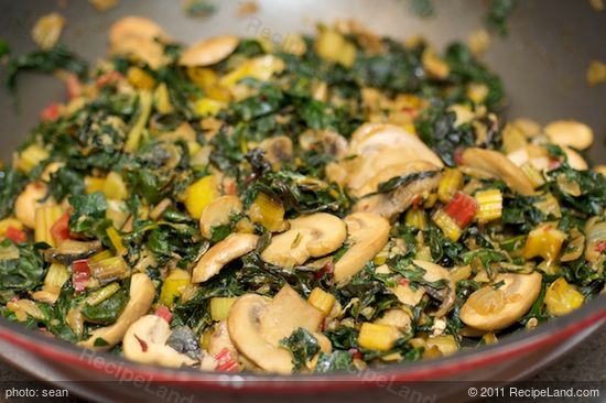 Add the chard leaves, stems and kale leaves, stirring,