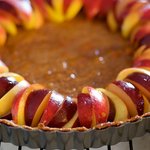 Arrange peach and plum slices neatly over tart, whatever way you prefer. 
