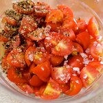 In a bowl, add the quartered cherry tomatoes, salt and black pepper to taste, 