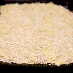 Place the oats, coconut, and almonds on a baking sheet, mix well and spread evenly. 