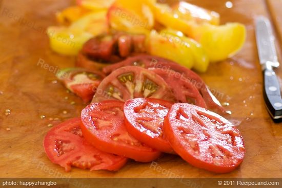 Slice the cored tomatoes into 1/2-inch slices.