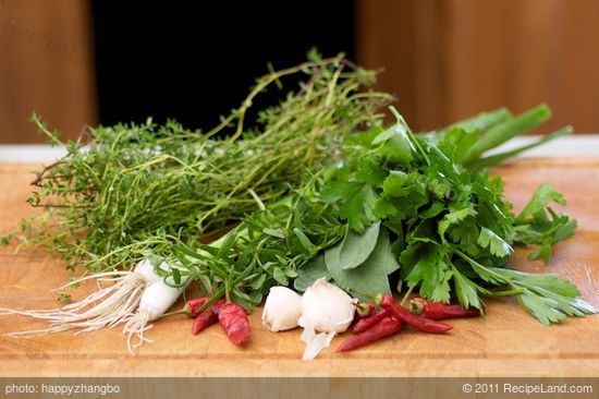 Wash well all the herbs, and let's work on chopping up the herbs, garlic and red chili peppers first.