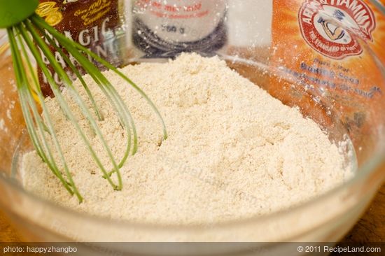 In a large bowl, whisk together the flours, corn meal, baking powder, baking soda and salt.