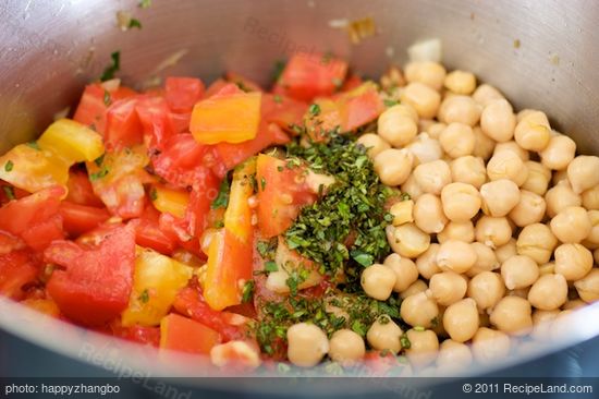 Add the chick peas, tomatoes, herbs,