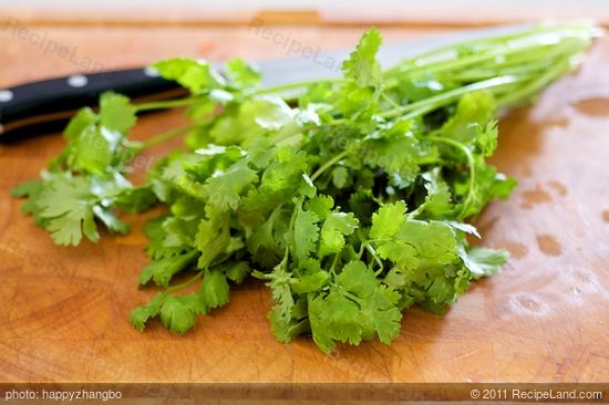 When it's close to the end of simmering, wash the cilantro well and chop them up.