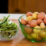 First, let's get the green beans and new potatoes well washed and snap off the ends of the green beans.
