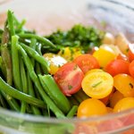 Place the green beans, tomatoes, parsley and basil into the large bowl with the seasoned potatoes. 
