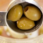 In a food processor, add the green olives.