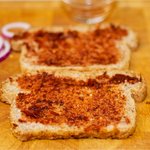 Spread each piece of bread with thin coating of pureed chiles,
