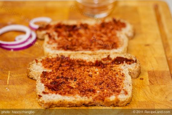 Spread each piece of bread with thin coating of pureed chiles,