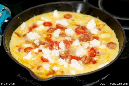 Sprinkle feta cheese over the egg mixture.