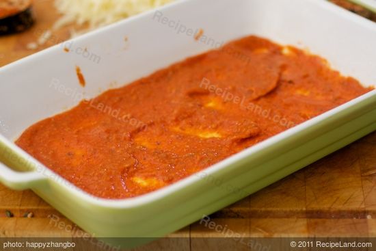 Time to assemble. Spread a thin layer of tomato sauce over the bottom of a 11 x 7 x 2 inch baking dish or a square dish. 